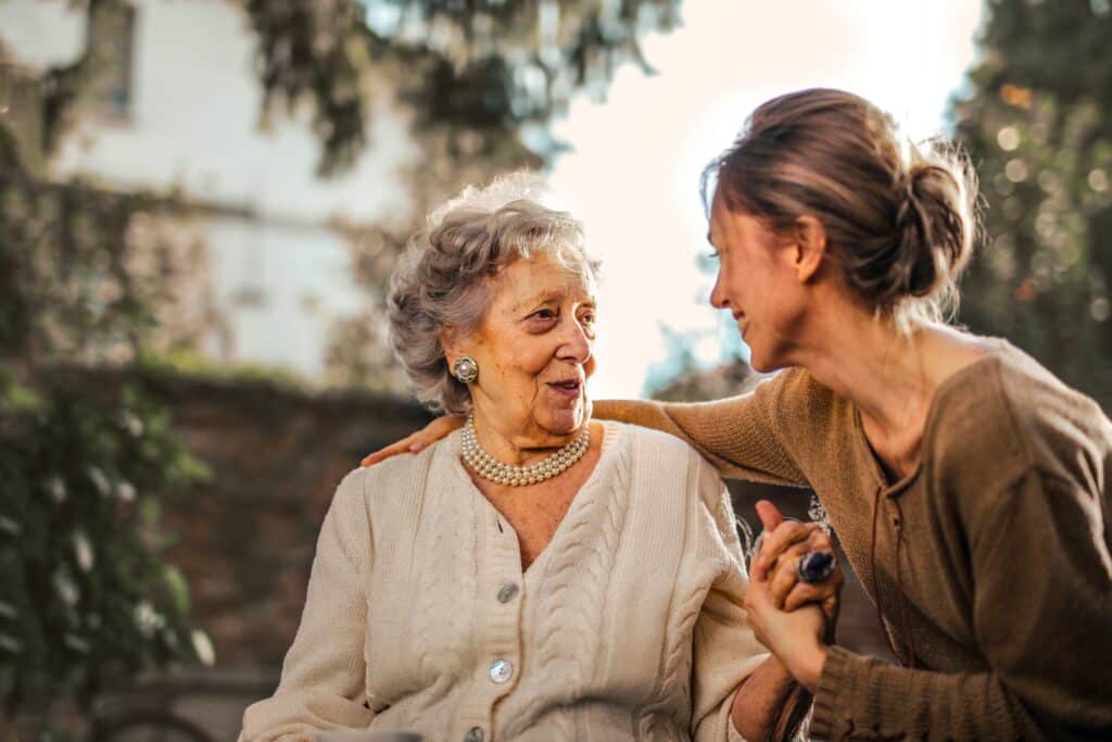 elderly woman talking to her daughter